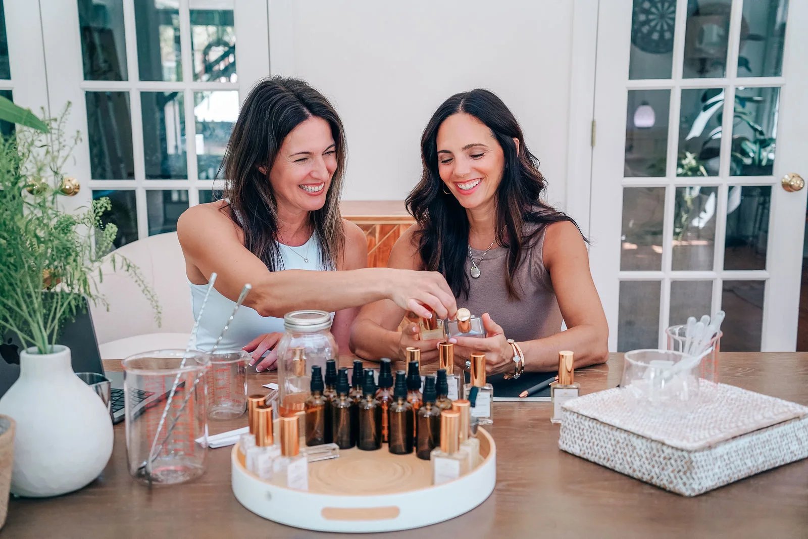 Lori and Holly blending fragrance at their worktable